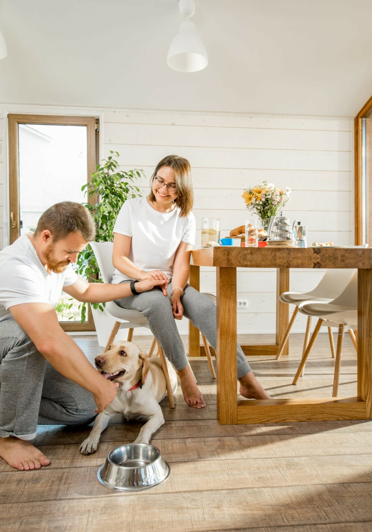 Young couple with dog at home | Steadham Flooring LLC